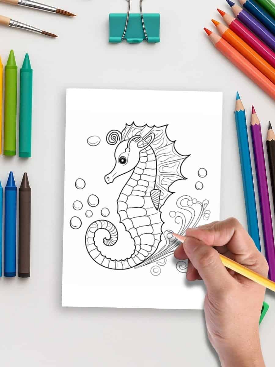 Coloring page of a seahorse for preschoolers with various colored markers and crayons.