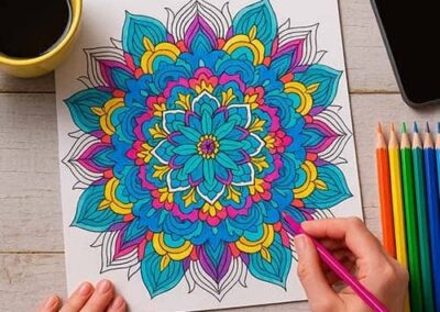 Colorful mandala coloring page on a preschool educational activity table.